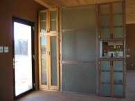 Foyer cabinets are aluminum frames with tempered glass panels and shelves.